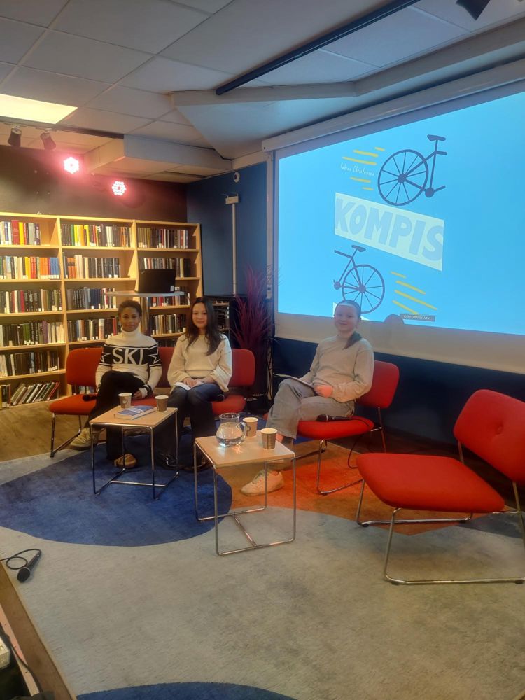 en person og en person som sitter i stoler foran en projektorskjerm